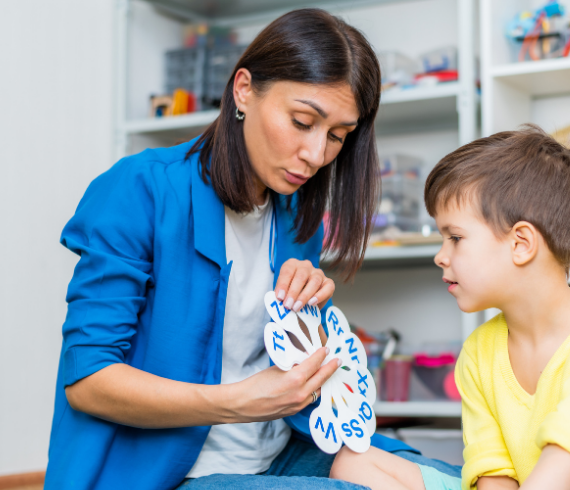 Speech and language therapist with child