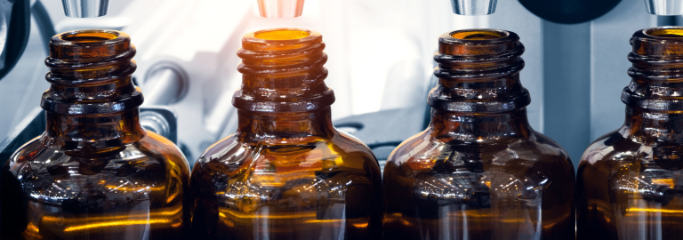 Rosemont Pharmaceuticals - Close up of liquid medicine bottles being filled