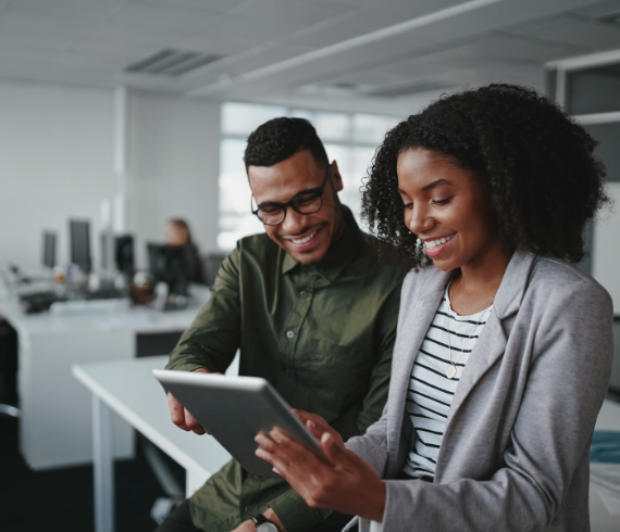 Rosemont Pharmaceuticals - Man and woman smiling in an office looking at a tablet device