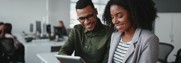 Rosemont Pharmaceuticals - Man and woman smiling in an office looking at a tablet device