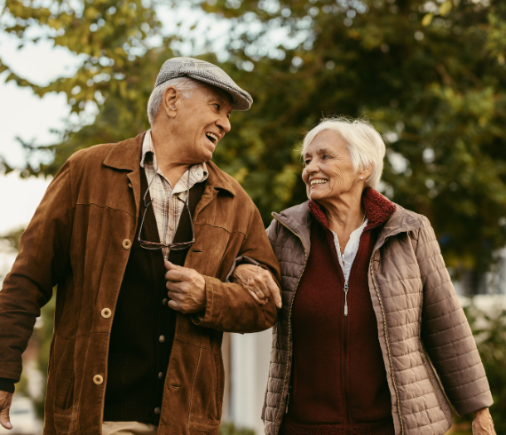 Older couple walking arm in arm