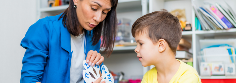 Rosemont Pharmaceuticals - Speech and language therapist talking to a child