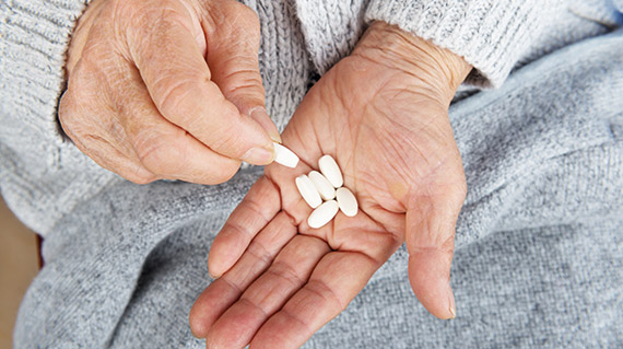 Rosemont Pharmaceuticals - Elderly patient with tablets in hand