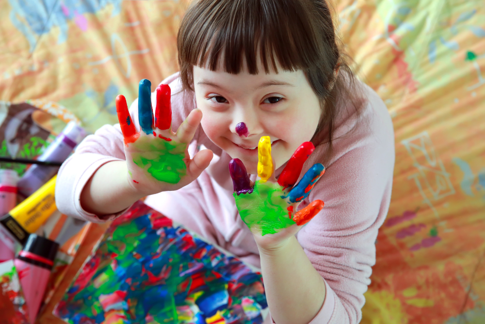 Child showing hands after finger painting