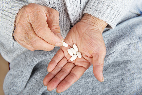 Older adult holding tablets